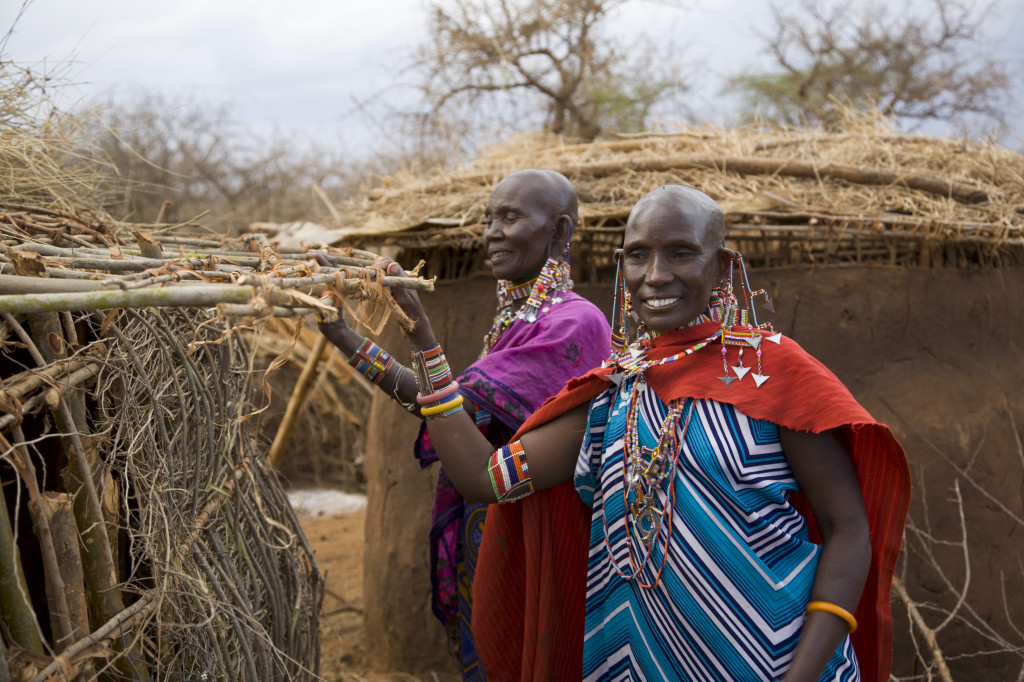 Two-masai-woman-preparing-the-roof-of-their-mud-house-000010121279_Full